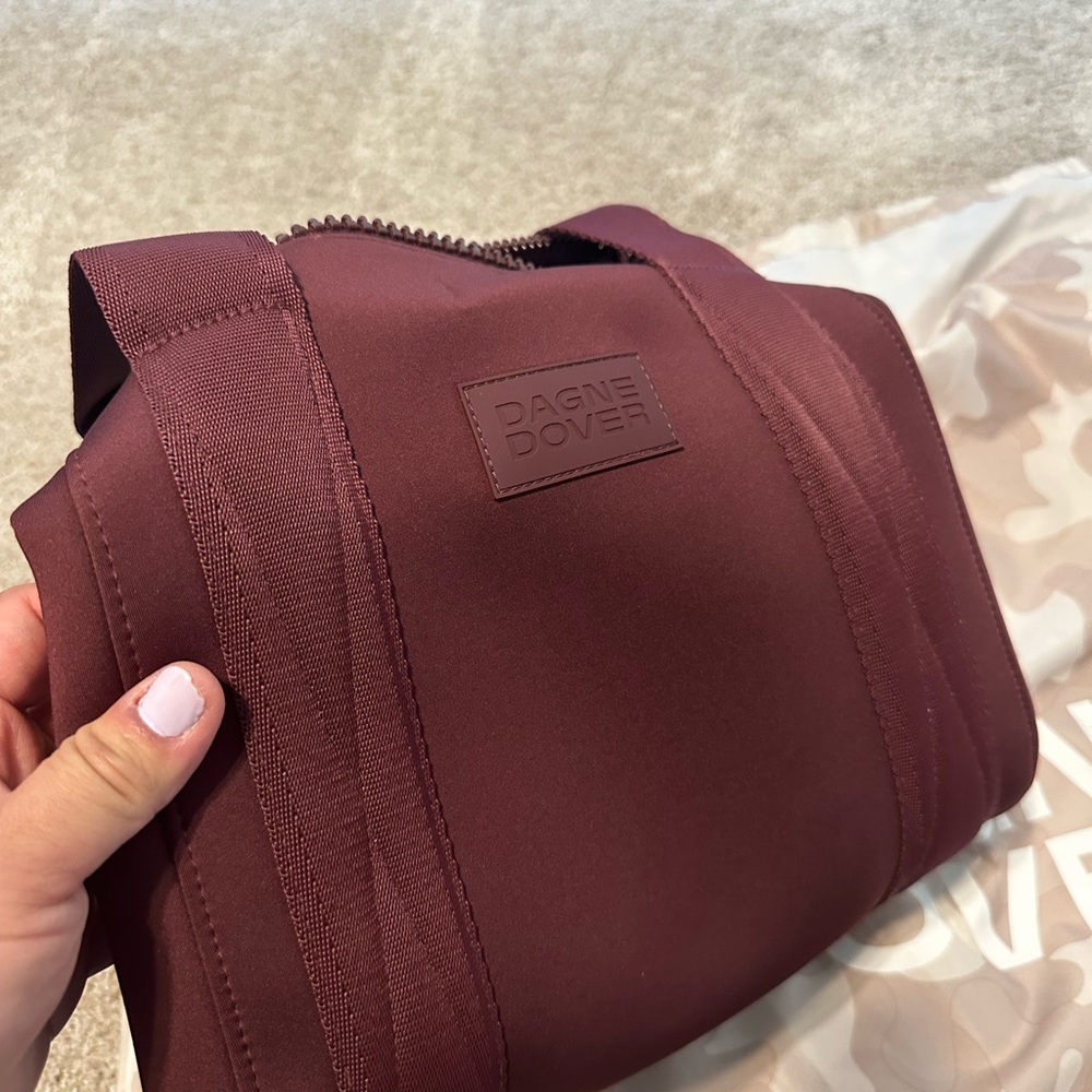 Brand new Dagne Dover small landon carry all bag in currant. Discontinued color